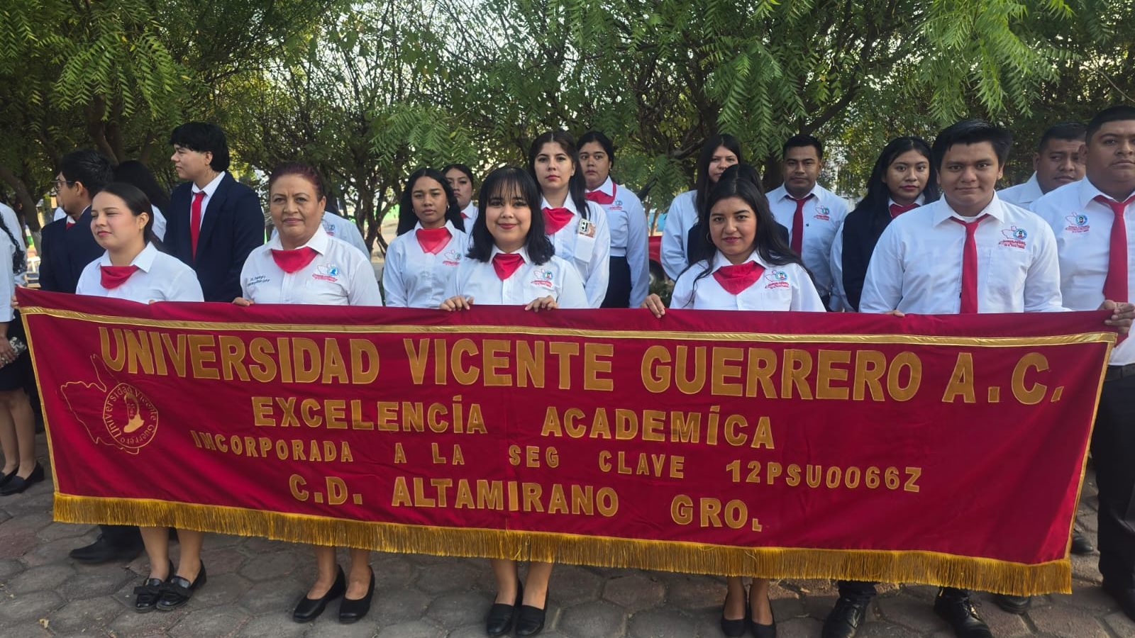 Comunidad de la Universidad Vicente Guerrero reunida con su estandarte institucional